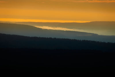 Silhouette landscape against sky during sunset