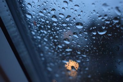 Close-up of raindrops on glass window