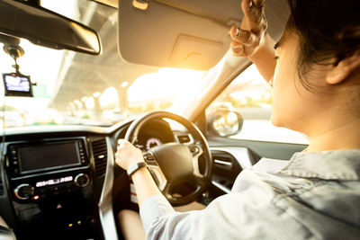 Rear view of man driving car