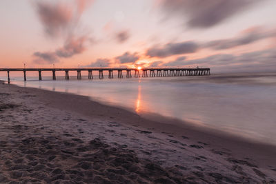 Scenic view of beach against sky during sunset