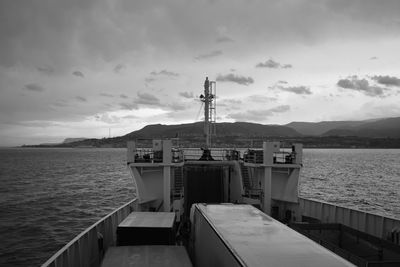 Ship moored at harbor against sky