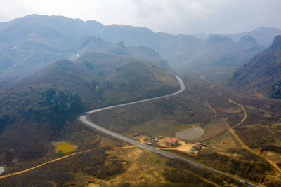 High angle view of road amidst mountains against sky