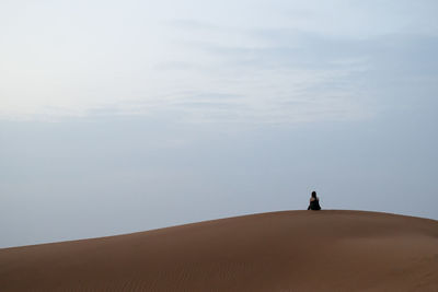 Rear view of a man standing on desert