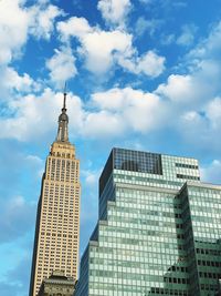 Low angle view of buildings against cloudy sky