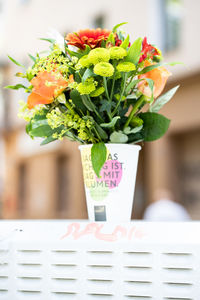 Close-up of cup filled with flowers on table