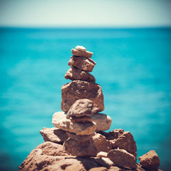 Close-up of pebbles on beach against sky