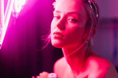 Close-up portrait of young woman looking away