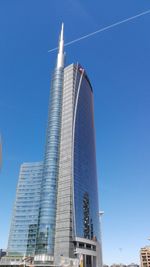 Low angle view of skyscraper against clear blue sky