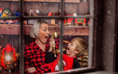 Portrait of smiling woman sitting in kitchen