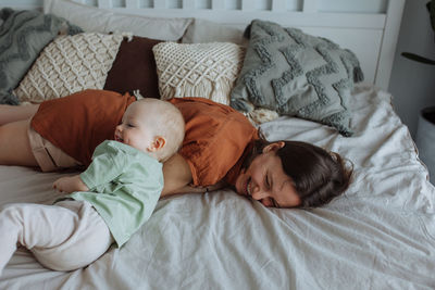 High angle view of baby sleeping on bed at home