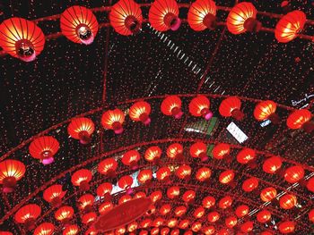 Low angle view of illuminated lanterns hanging on ceiling