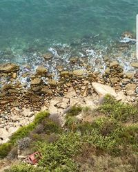 High angle view of rock by sea