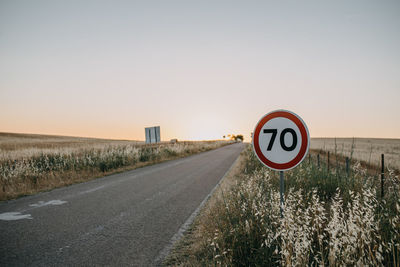 Road sign against clear sky