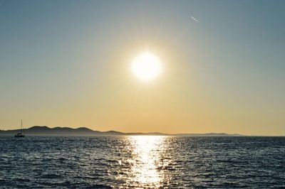 Scenic view of sea against clear sky during sunset