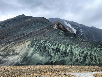 Side view of man standing against mountain