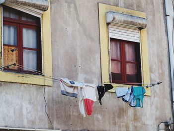 Low angle view of clothes drying against building