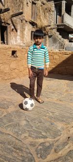 Full length of a boy playing soccer ball