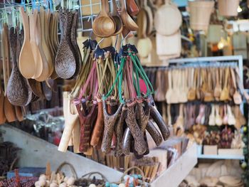 Close-up of slingshots hanging in store for sale