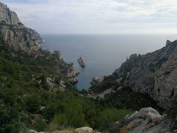 Scenic view of sea and mountains against sky