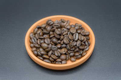 Close-up of roasted coffee beans on table