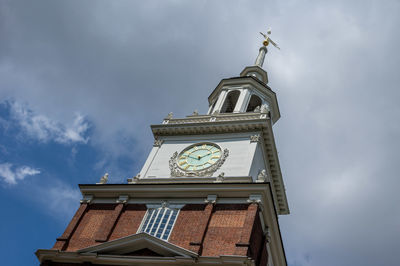 Low angle view of clock tower against sky