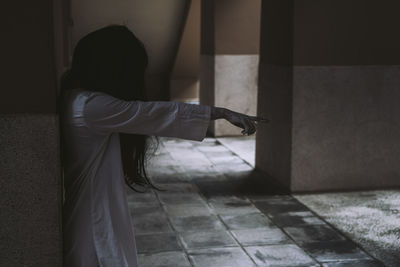 Young woman standing in building