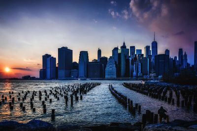 View of skyscrapers against cloudy sky