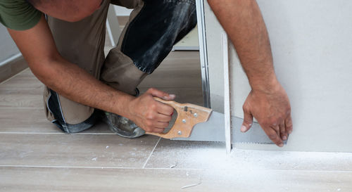 Midsection of man working on floor