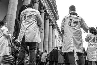 Low angle view of people walking in city