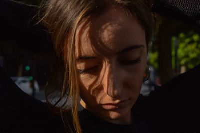 Close-up of young woman looking down