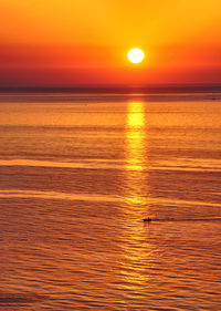 Scenic view of sea against romantic sky at sunset