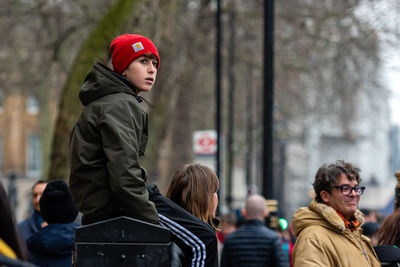 Side view of man looking at camera