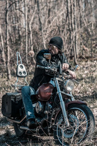 Man riding motorcycle in forest