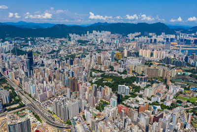 High angle view of modern buildings in city against sky