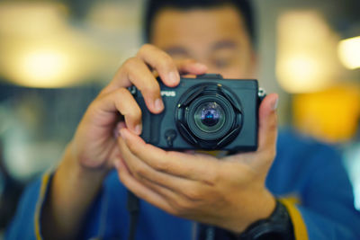 Close-up of man holding camera