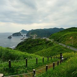 Scenic view of sea and mountains against sky