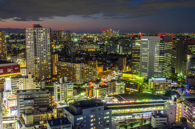 High angle view of illuminated buildings in city at night