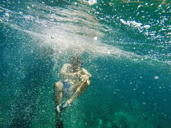 High angle view of man swimming in sea