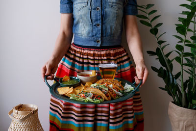 Midsection of woman standing on table