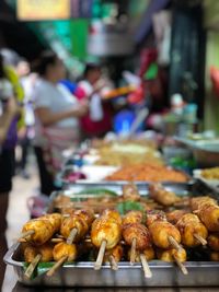 Meat on skewers for sale at market