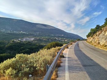 Narrow road along countryside landscape