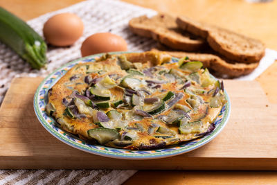 Zucchini and red onion omelette. high angle view of omelette on table
