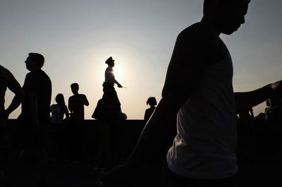 Low angle view of silhouette man against sky