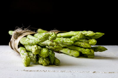 Close-up of vegetables on table against black background