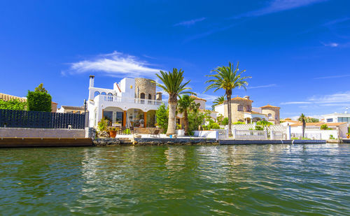 The house with palm by the water at the resort in spain