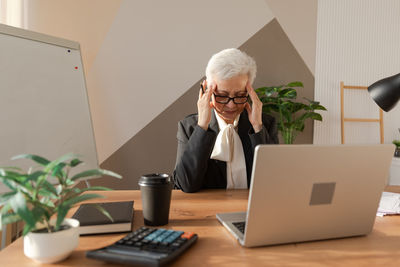 Young woman using laptop while sitting at home