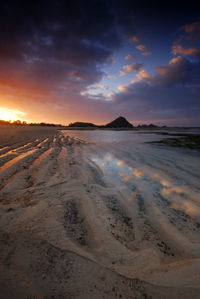 Scenic view of beach against sky during sunset