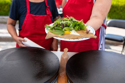 Midsection of man preparing food