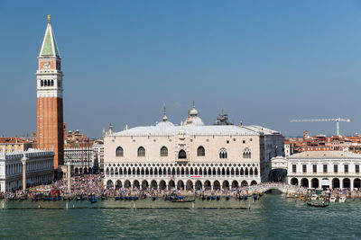 View of buildings in city against clear sky