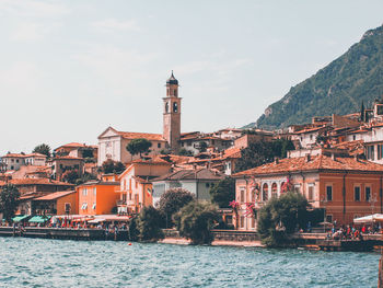 Buildings at waterfront against sky